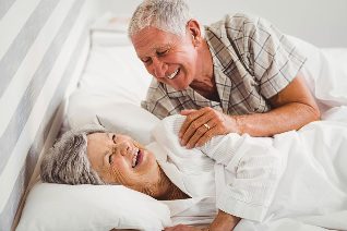 An elderly couple in bed